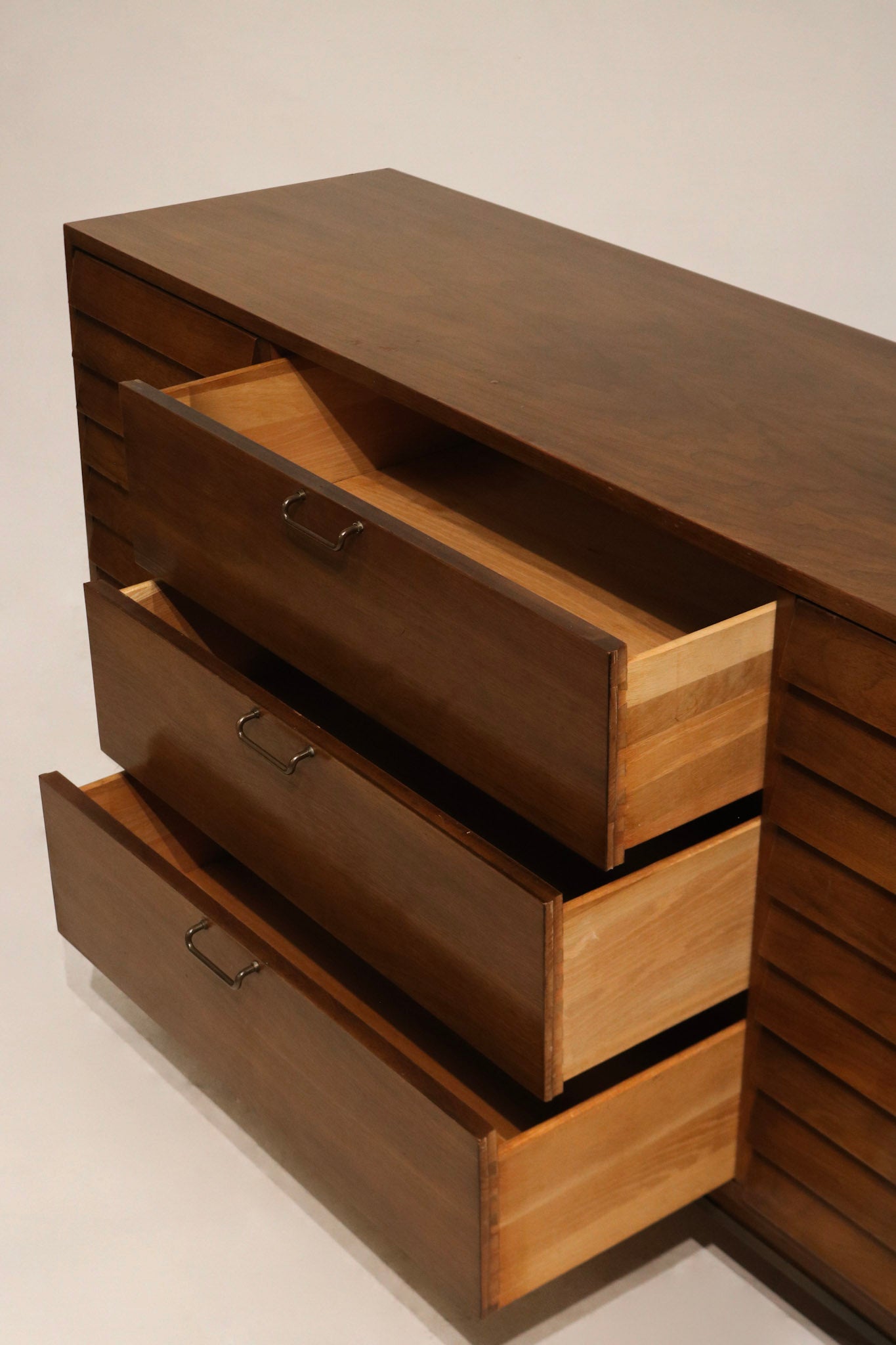 Close shot of surface patina and tiny imperfections on walnut finish; minimal blemishes visible on close inspection