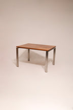 Full view of Room & Board dining table made of solid wood and steel, showcasing its sturdy structure