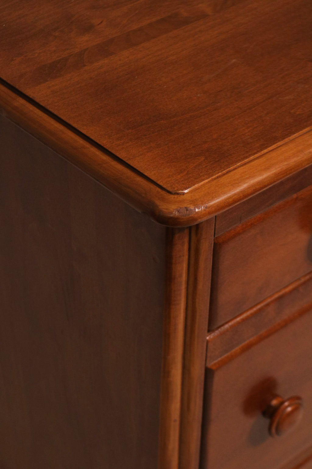 View of dresser top surface with smooth maple finish and natural wood texture