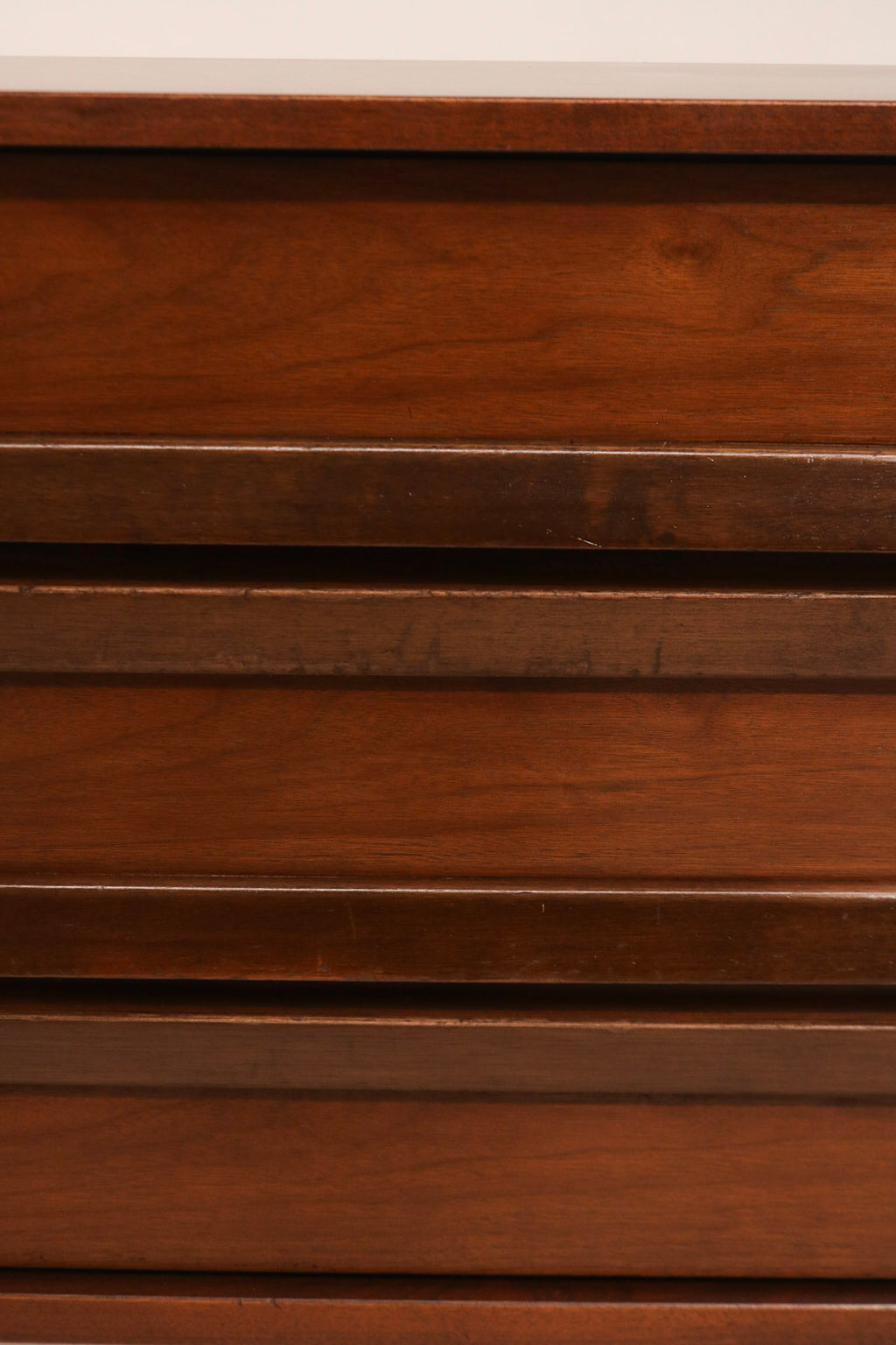 Top surface of dresser showing light scratches and wear, aged patina in walnut wood finish