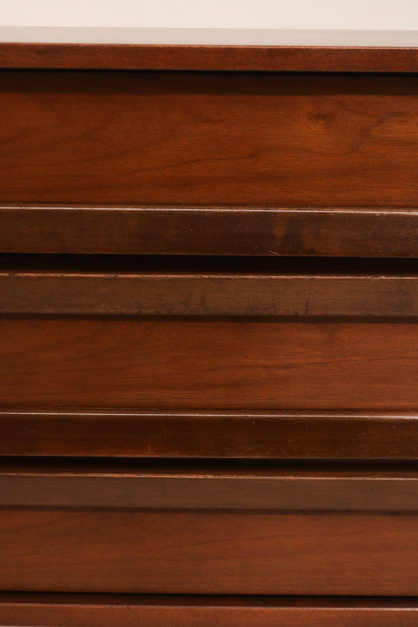 Top surface of dresser showing light scratches and wear, aged patina in walnut wood finish