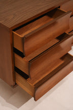 Leg design detail of dresser displaying mid-century taper and walnut finish