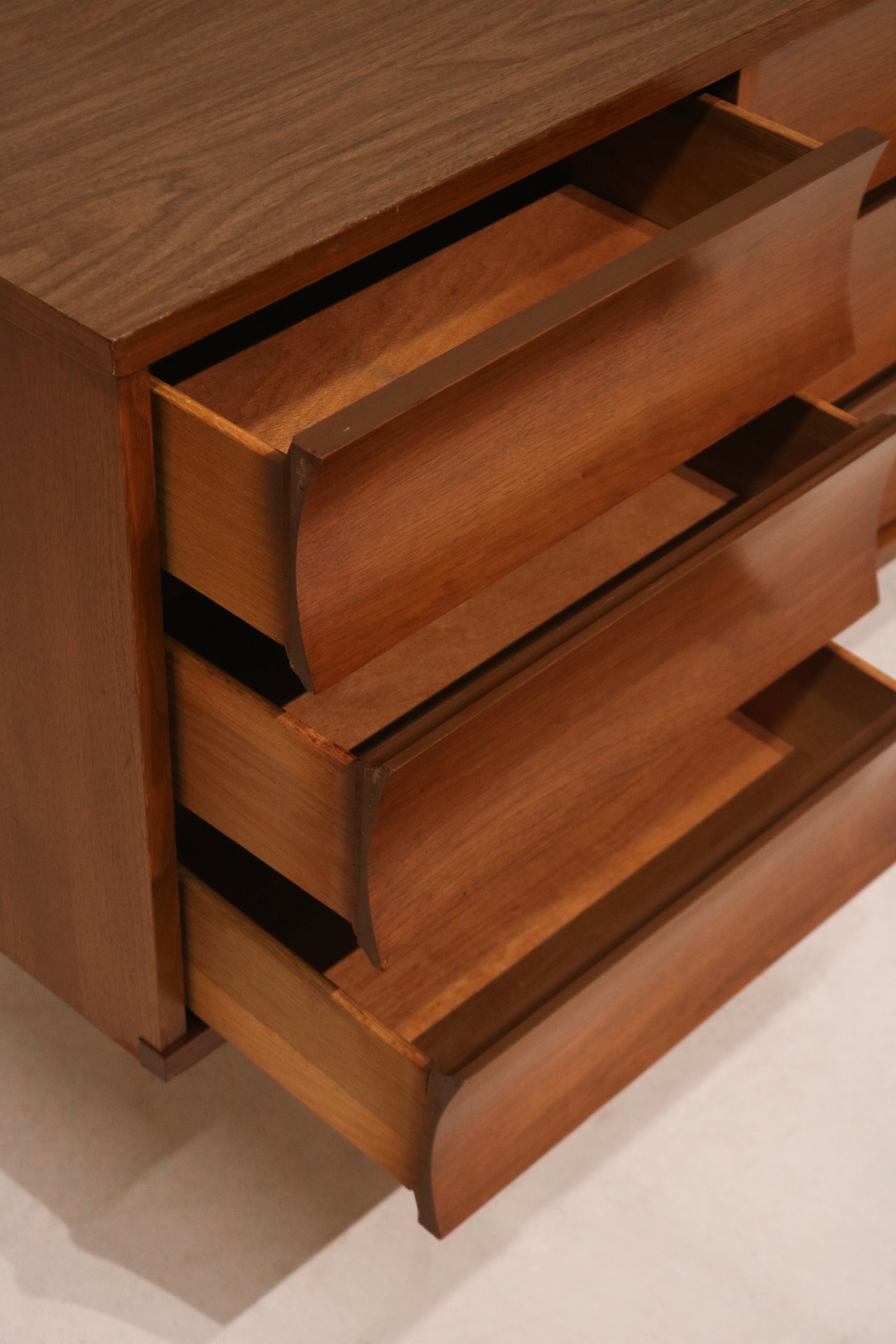 Leg design detail of dresser displaying mid-century taper and walnut finish