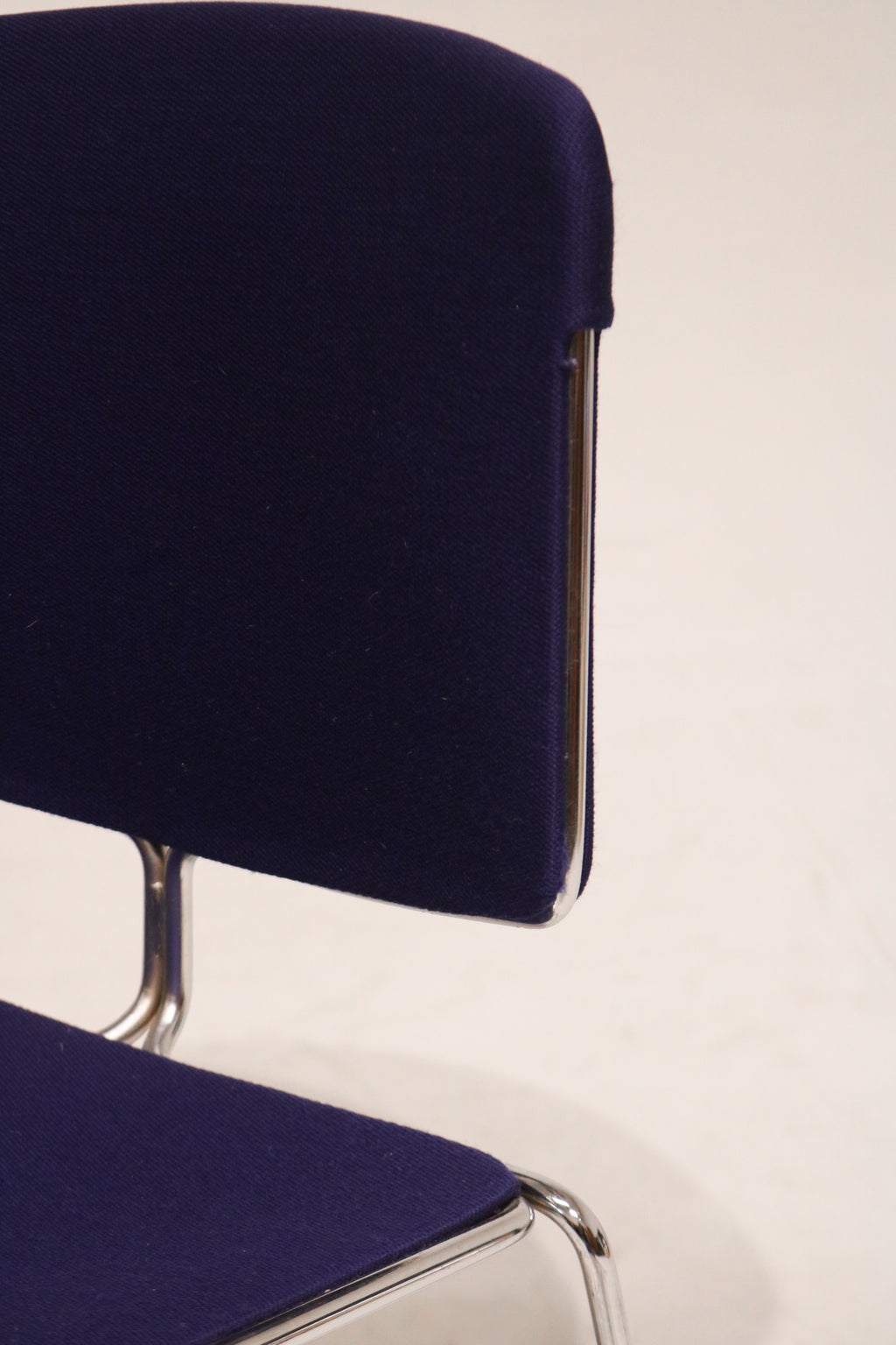 Close-up of backrest with the textured blue fabric and clean seams