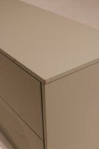 Texture detail shot of the oat colored lacquered wood grain