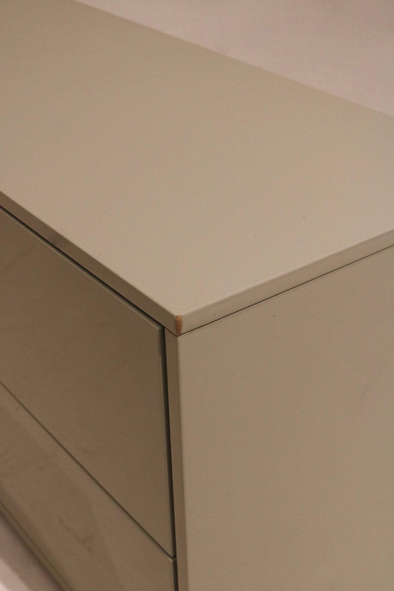 Texture detail shot of the oat colored lacquered wood grain