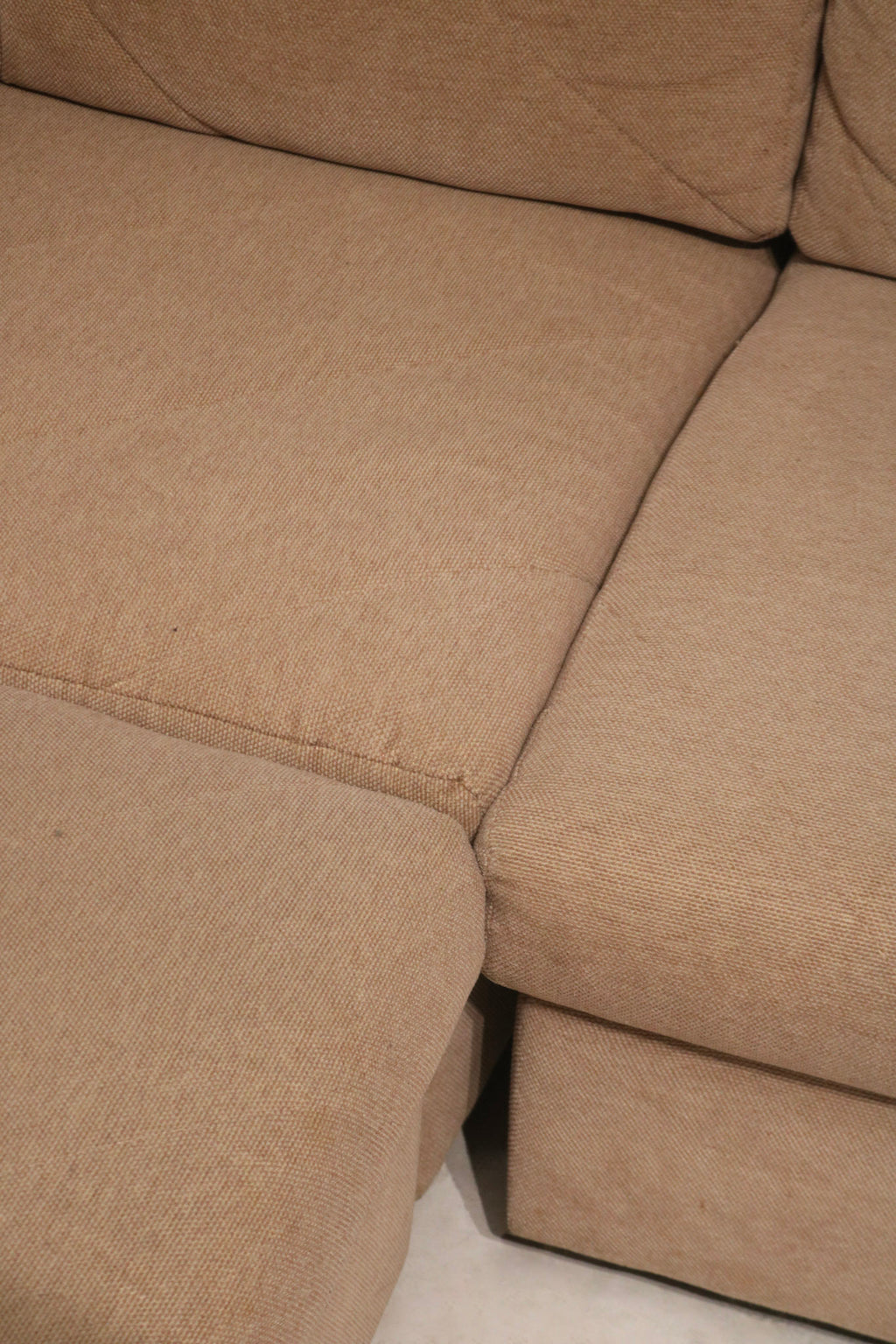 Texture macro of woven fabric on Mcm sofa couch showing thread detail, color blend and soft tactile surface in brown fabric material