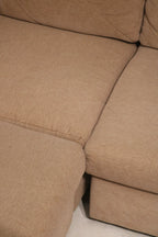 Texture macro of woven fabric on Mcm sofa couch showing thread detail, color blend and soft tactile surface in brown fabric material