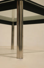 Close-up shot of leg wear on steel base, emphasizing vintage character and authenticity