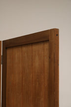 Macro shot of corner and hinge area on pine screen, showing worn brass tones, screw heads and solid vintage joinery.