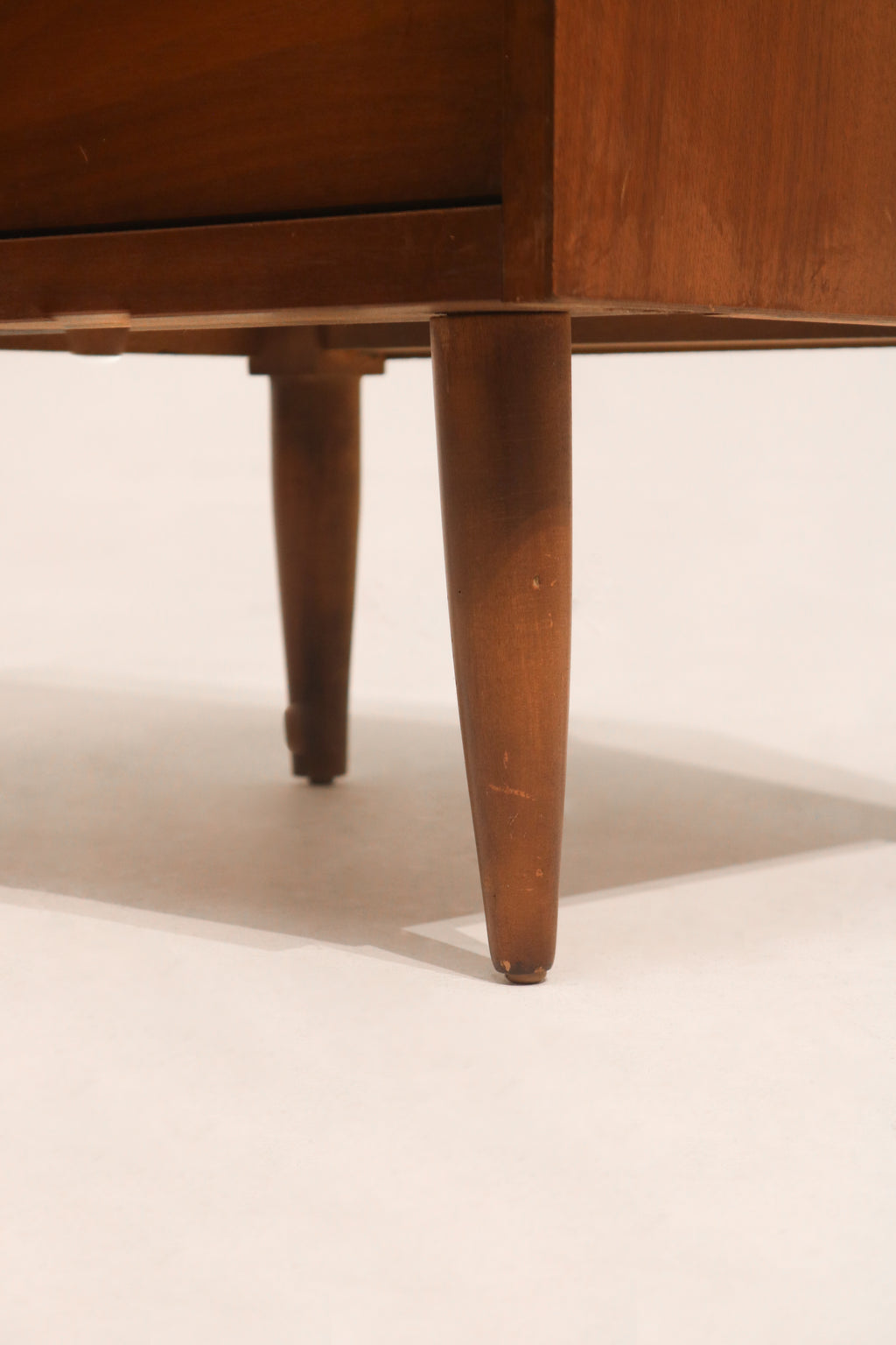 Side angle showing depth and warm walnut color of mid-century nightstand