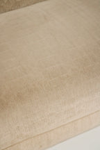 Close-up of exposed base and leg attachment area, champagne velvet fabric wrapped frame and reinforced junction with secure hardware visible
