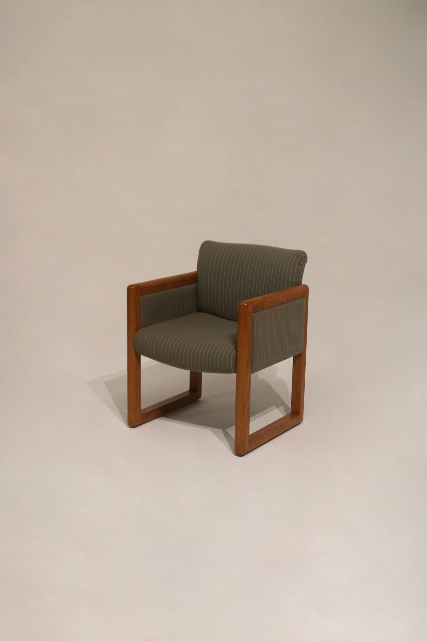 Front view of vintage mid-century modern club chair with natural oak wood frame and neutral upholstery — NYC