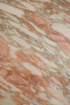 Edge and corner detail of solid marble table showing thickness, smooth polished edge and contemporary clean-cut profile.