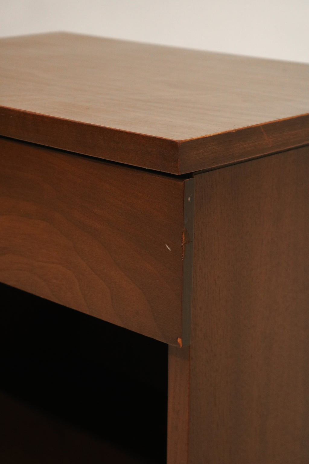 Angle view of walnut wood legs with sturdy construction and minimal wear