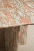 Underneath and junction detail of the marble table, seamless construction, solid stone build, no cracks or chips evident.