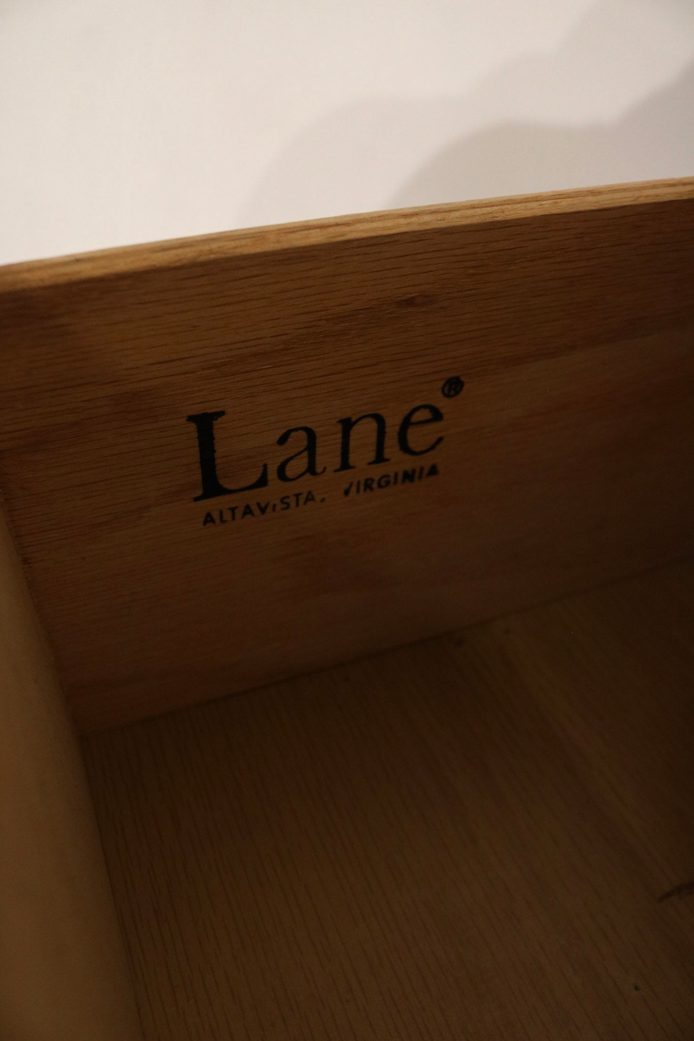 Three-quarter view highlighting proportions, tapered silhouette and vintage MCM aesthetic in walnut wood construction