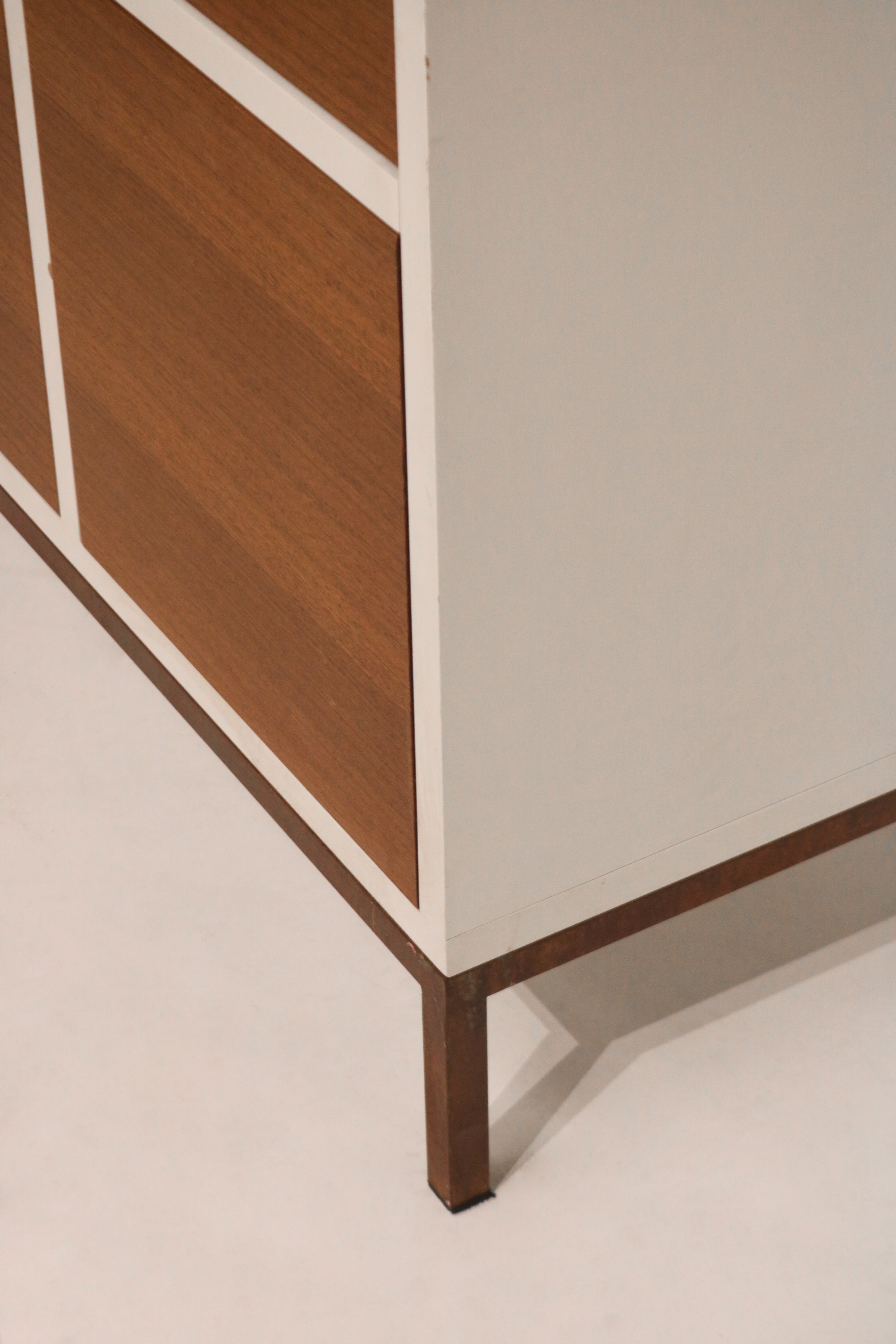 Angle shot of cabinet highlighting iron legs and heavy-duty wood construction