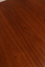 Angled view capturing expanded length of the table set for nine-seat arrangement