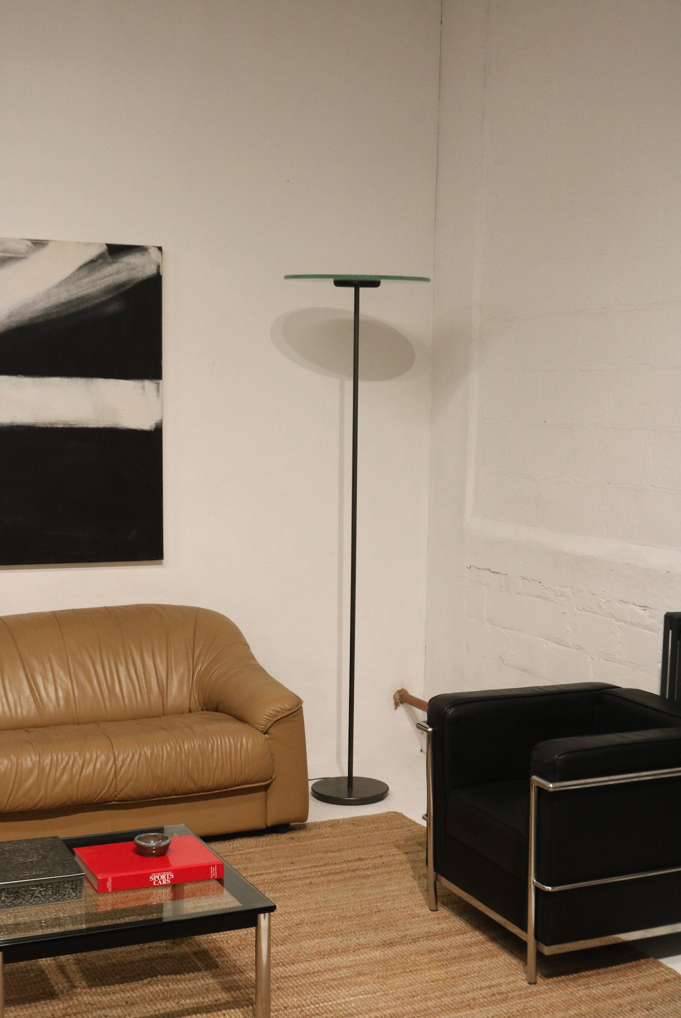 Close-up of the glass shade on the vintage Italian floor lamp, showcasing smooth transparent material and clean lines