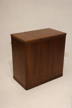 Detail: grouping of drawer handles on walnut wood desk showing metal pulls, patina and one handle missing black trim