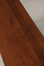 Top surface showing minor black marks on solid walnut finish