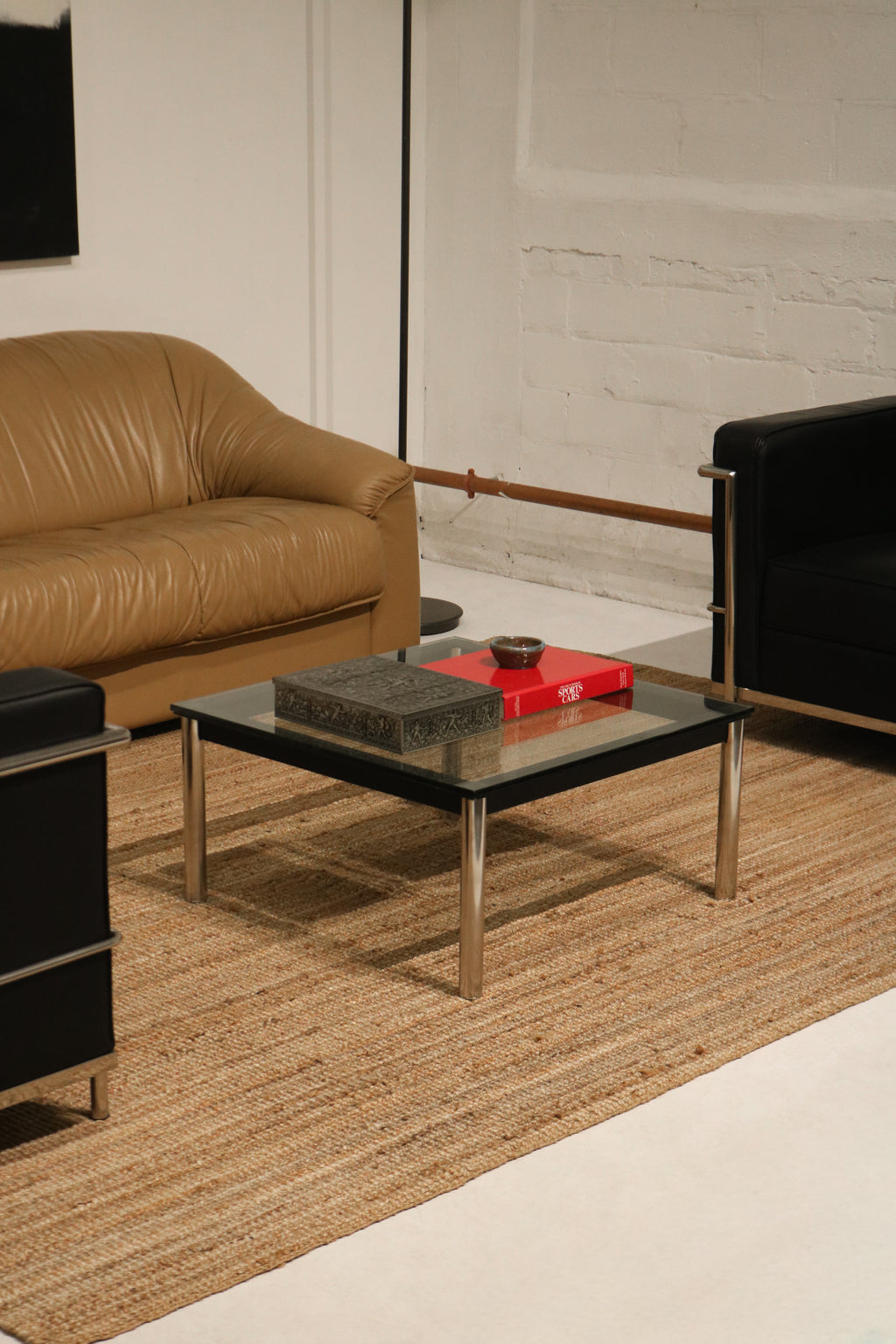 Detail of steel base with minor wear on the legs of Vintage Mcm Glass Coffee Table