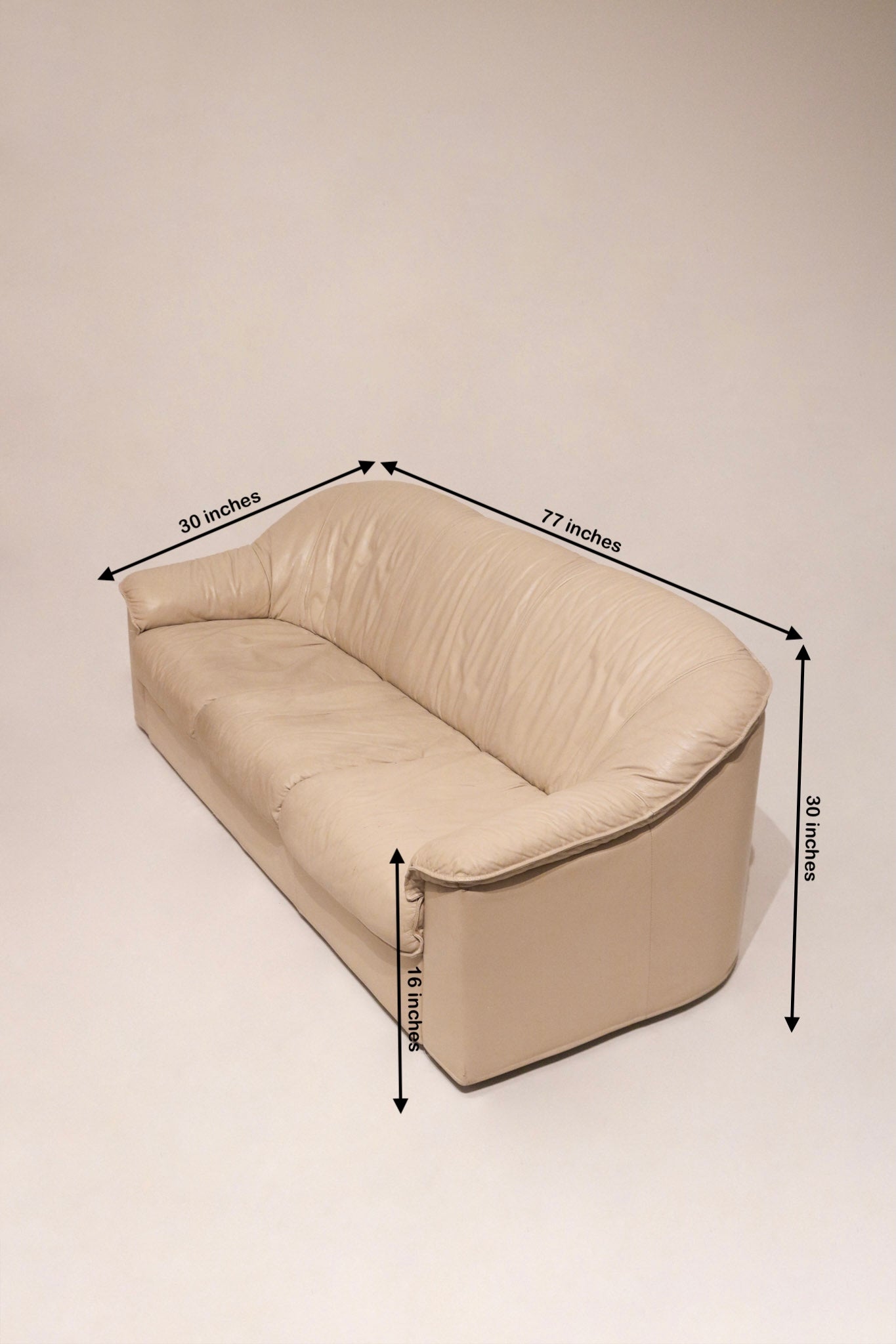 Dimensions view of beige leather Salotti Natuzzi sofa showing full measurements in inches