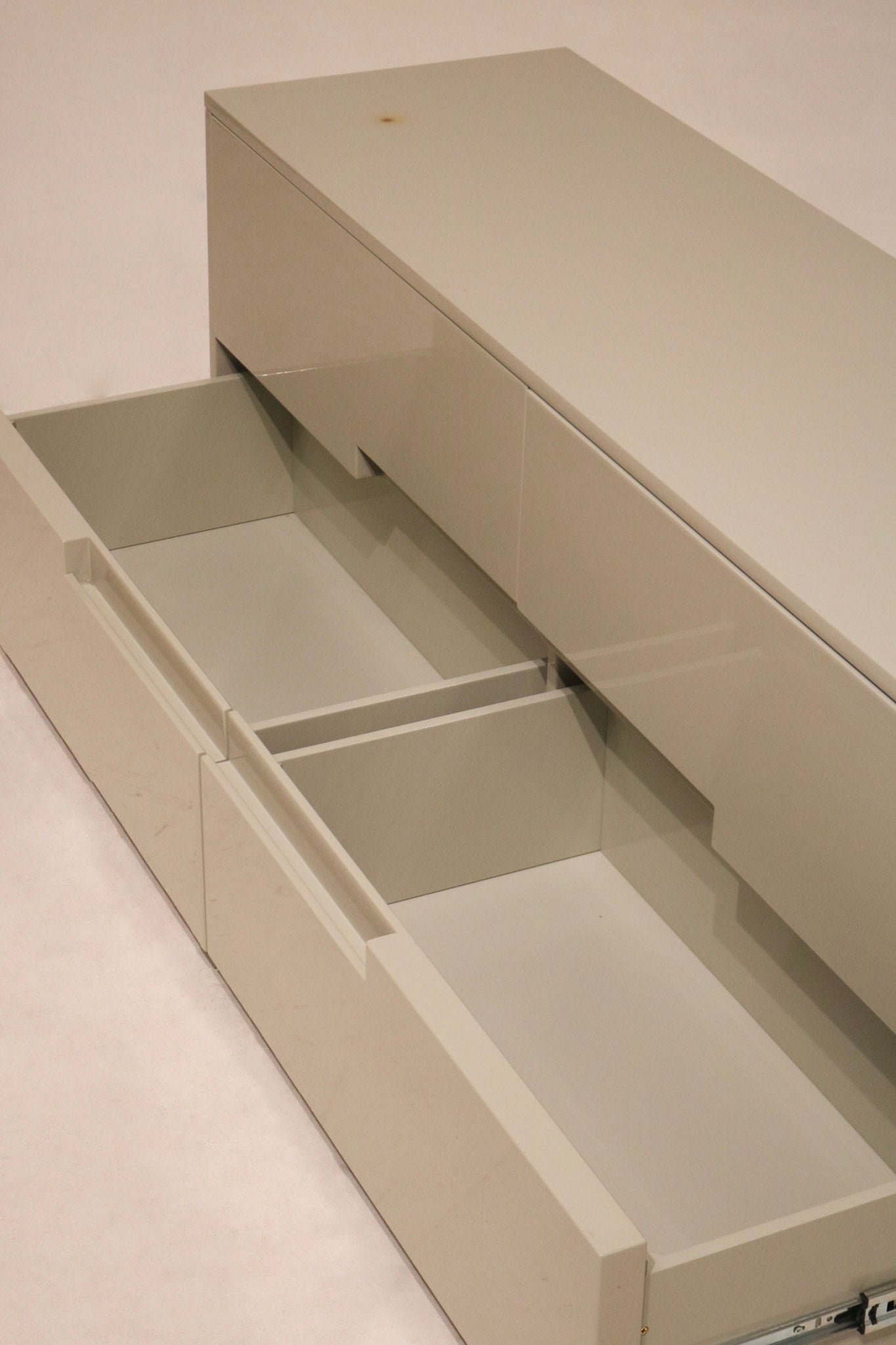 Lighting highlight across dresser surface showing luster of lacquer finish