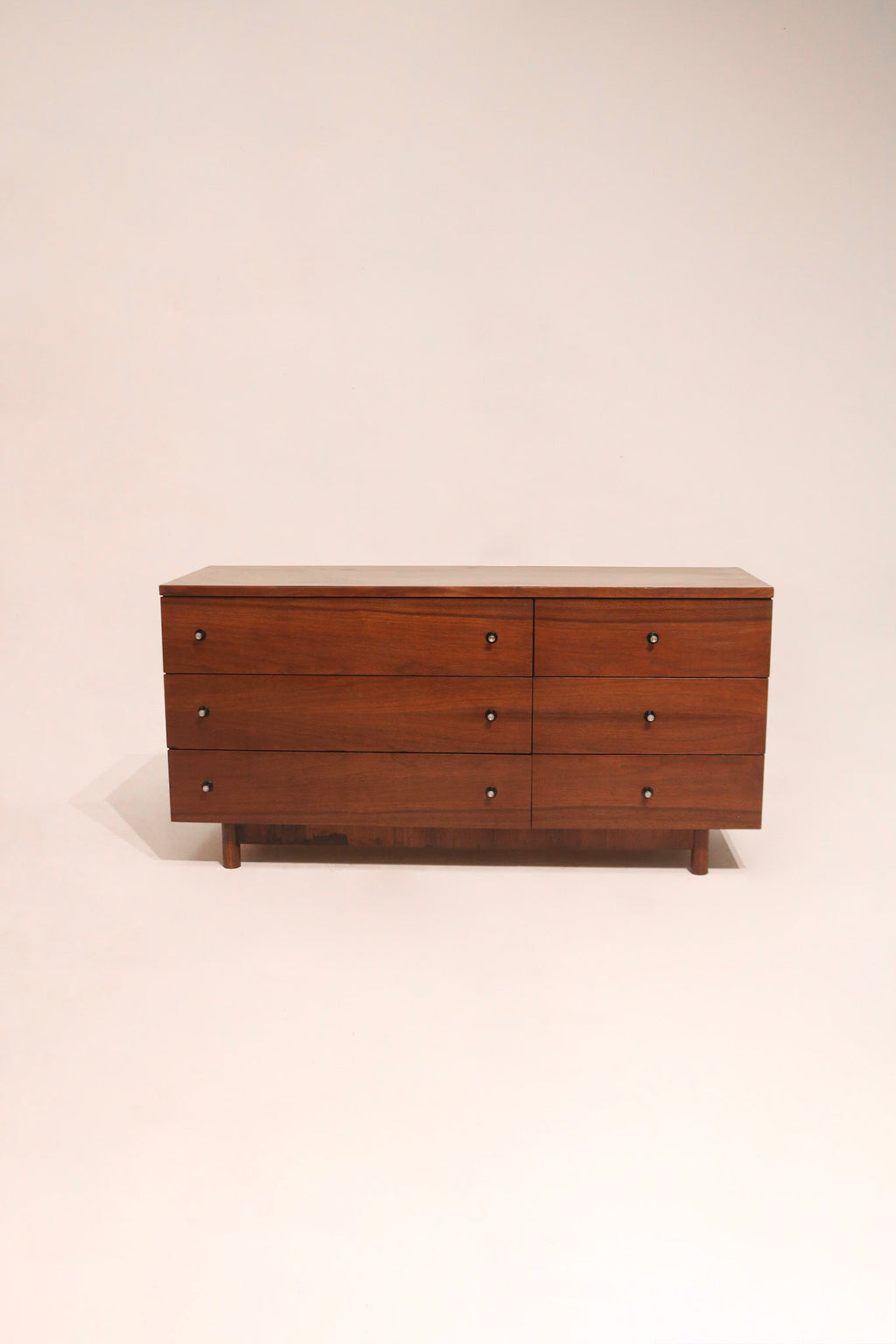 Full view of Mcm vintage walnut wood lowboy dresser by Stanley with six drawers and mid-century design