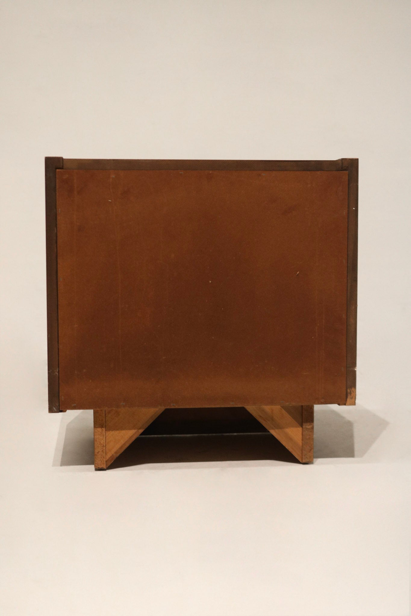 Underside/base detail: particle board base beneath walnut veneer, showing support structure and attachment points