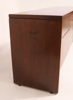 Underside view of credenza showing frame construction and leg alignment in hardwood