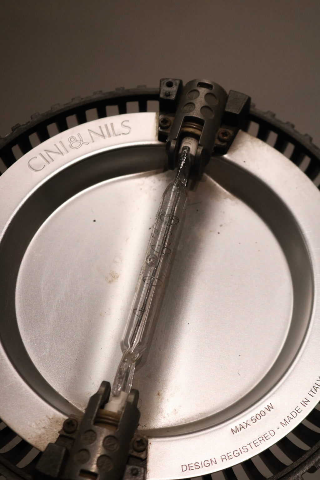 Close-up of lamp switch and control area, featuring clean metal design and functionality