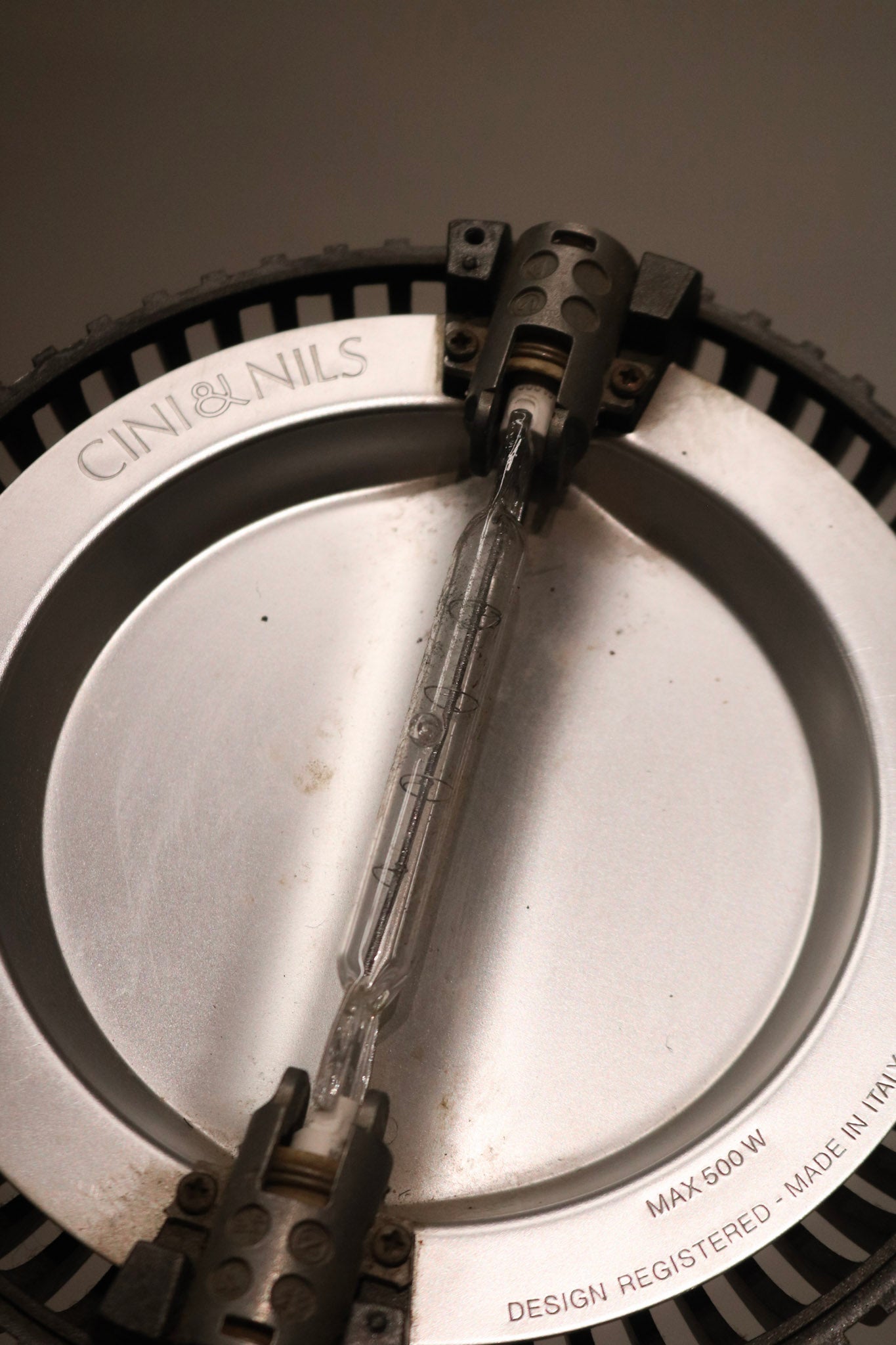 Close-up of lamp switch and control area, featuring clean metal design and functionality