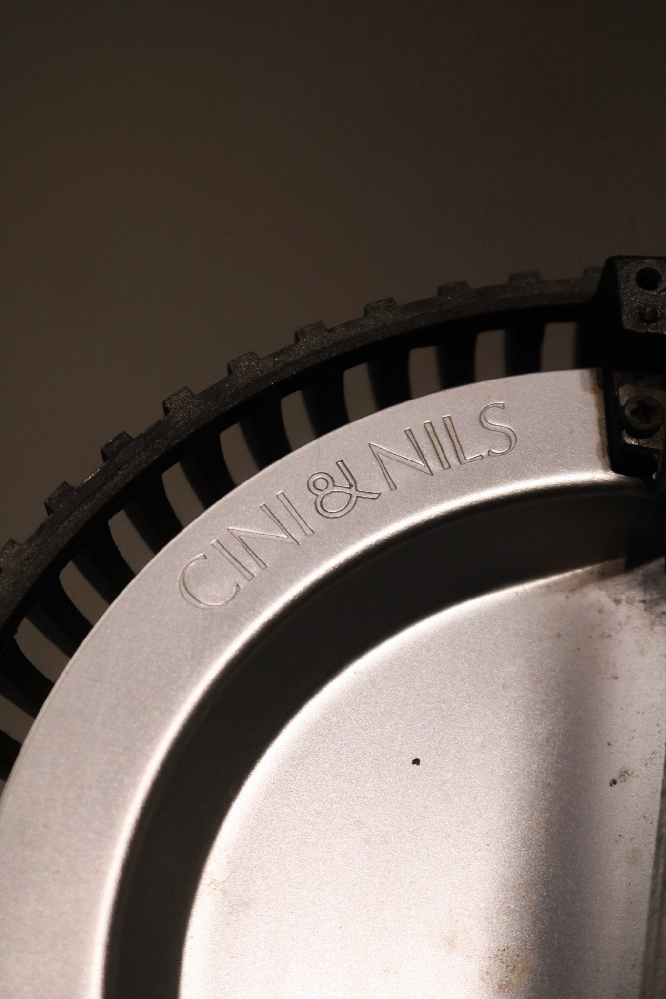 Angled shot of the lamp's upper section with bulb fixture and minimalist finishes