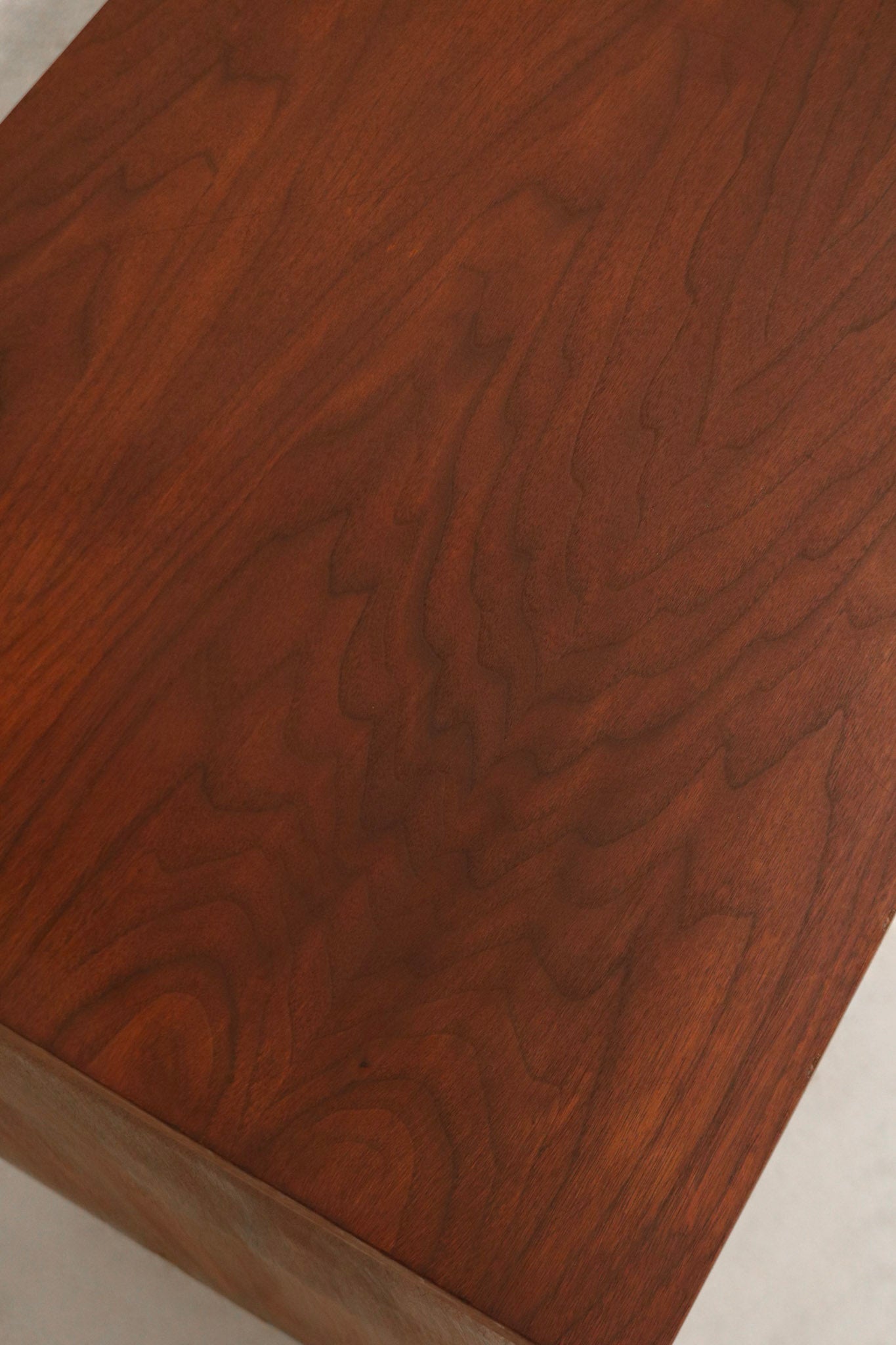 Side view showing the smooth walnut finish and sleek mid-century profile