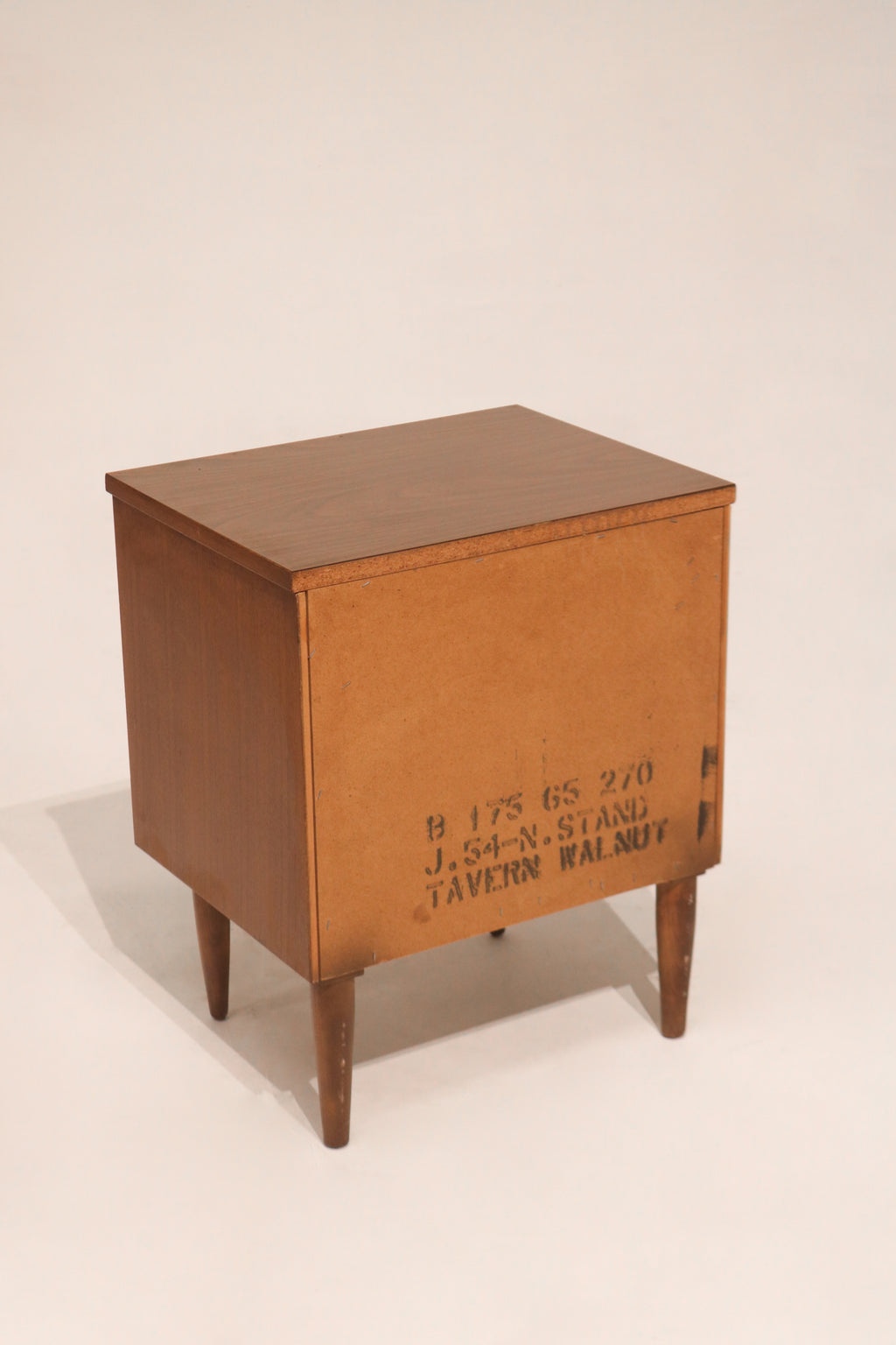 Top corner detail displaying wood tone contrast and craftsmanship of walnut nightstand