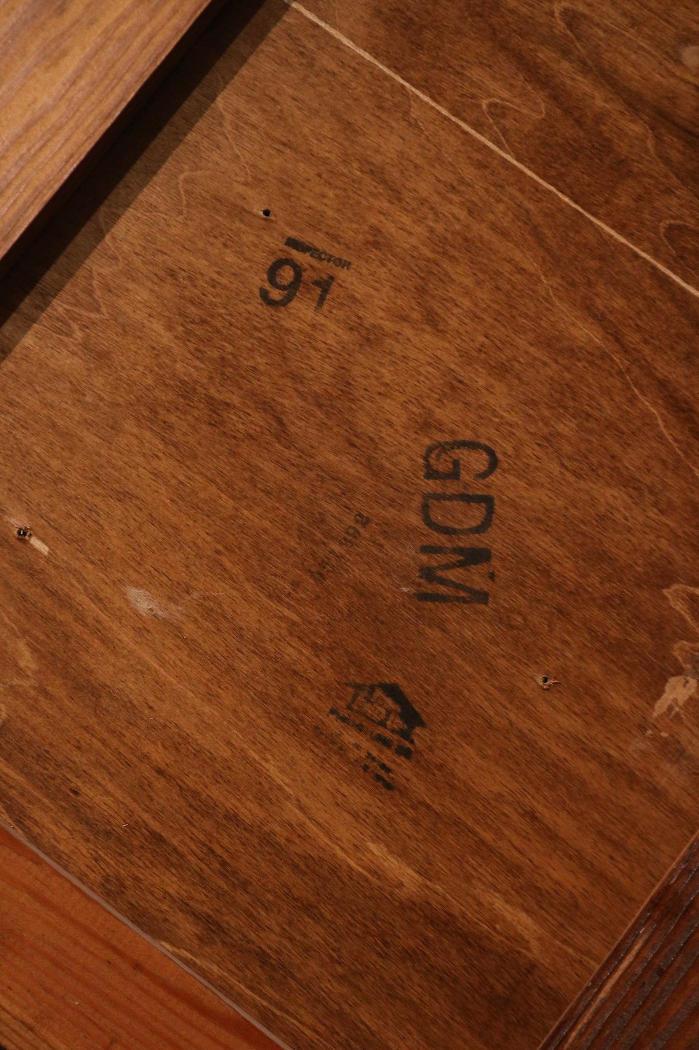 Close-up of stained oak wood surface showing vintage grain and smooth finish of the desk