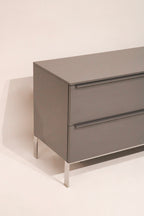 Open drawer showing spacious storage with clean interior of lacquered TV cabinet