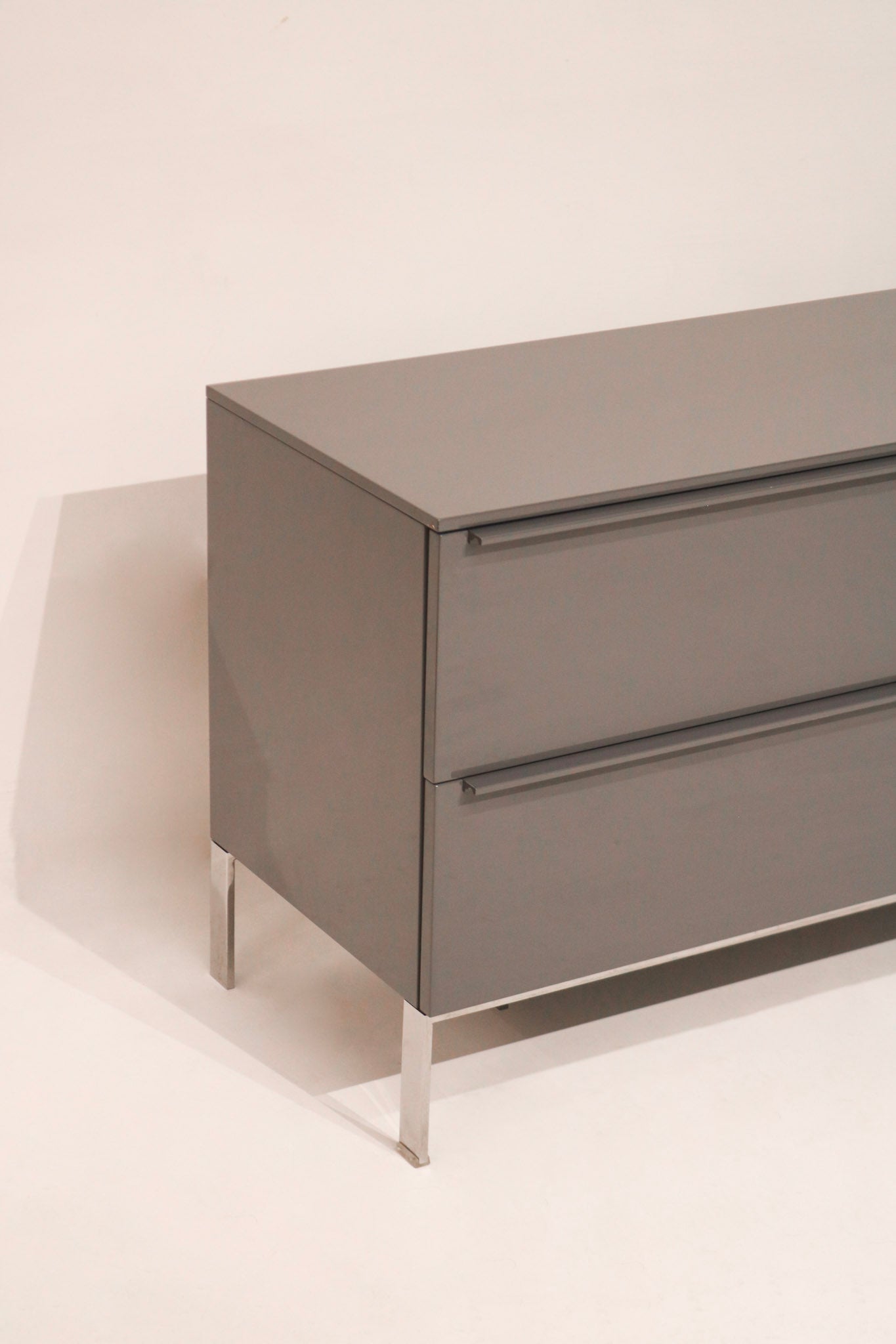 Open drawer showing spacious storage with clean interior of lacquered TV cabinet
