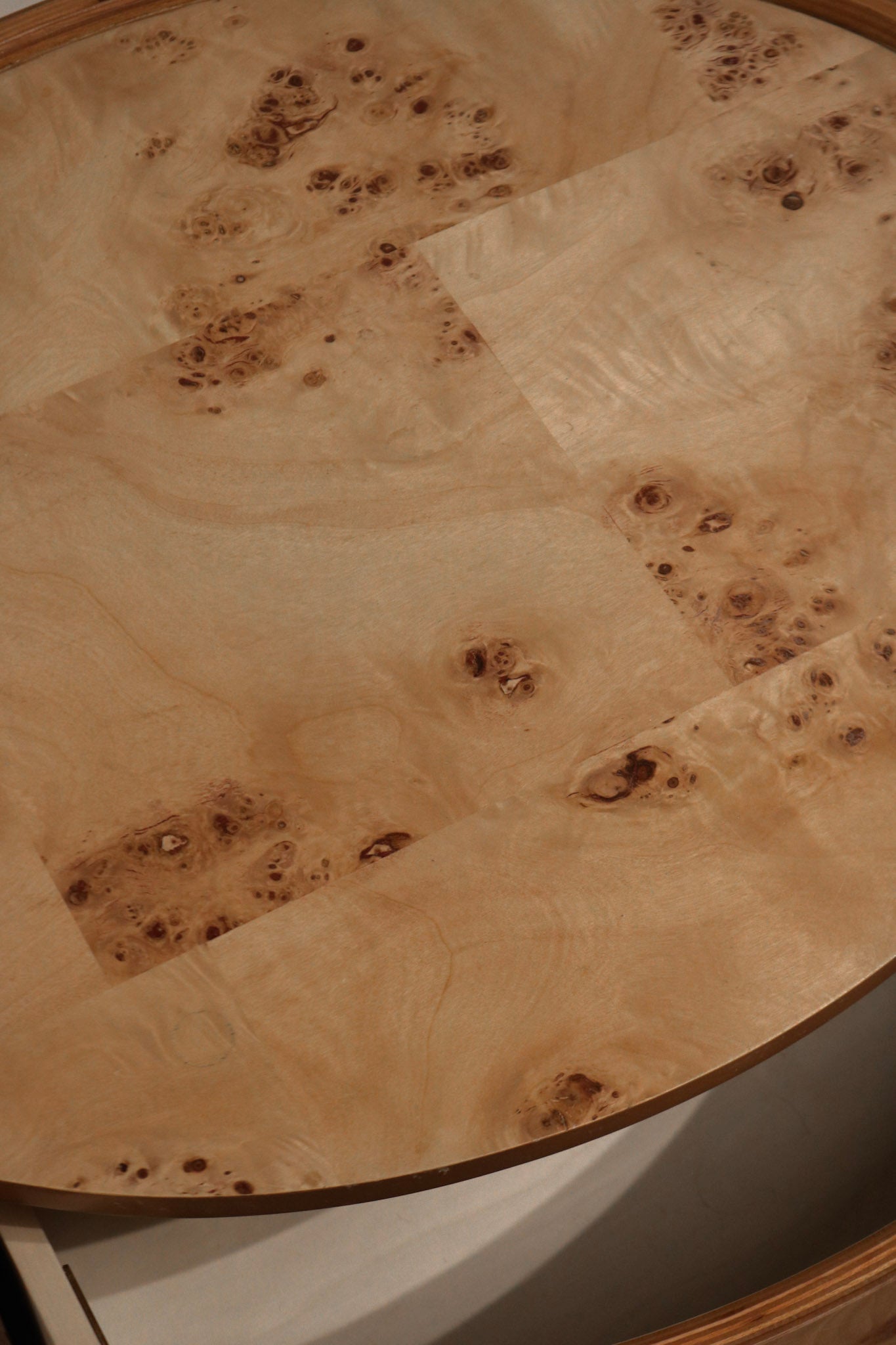 Textured view of elm burl veneer surface showing natural wood grain details in warm tones
