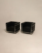 Hardware close-up on chrome base glides of LC2 chairs, pristine like-new condition