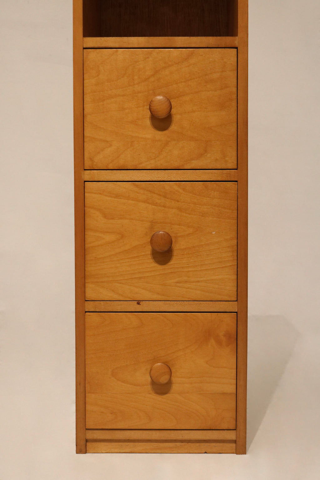 Close-up of drawer front on bookcase cabinet made of oak and particle board