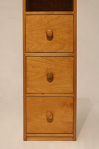 Close-up of drawer front on bookcase cabinet made of oak and particle board
