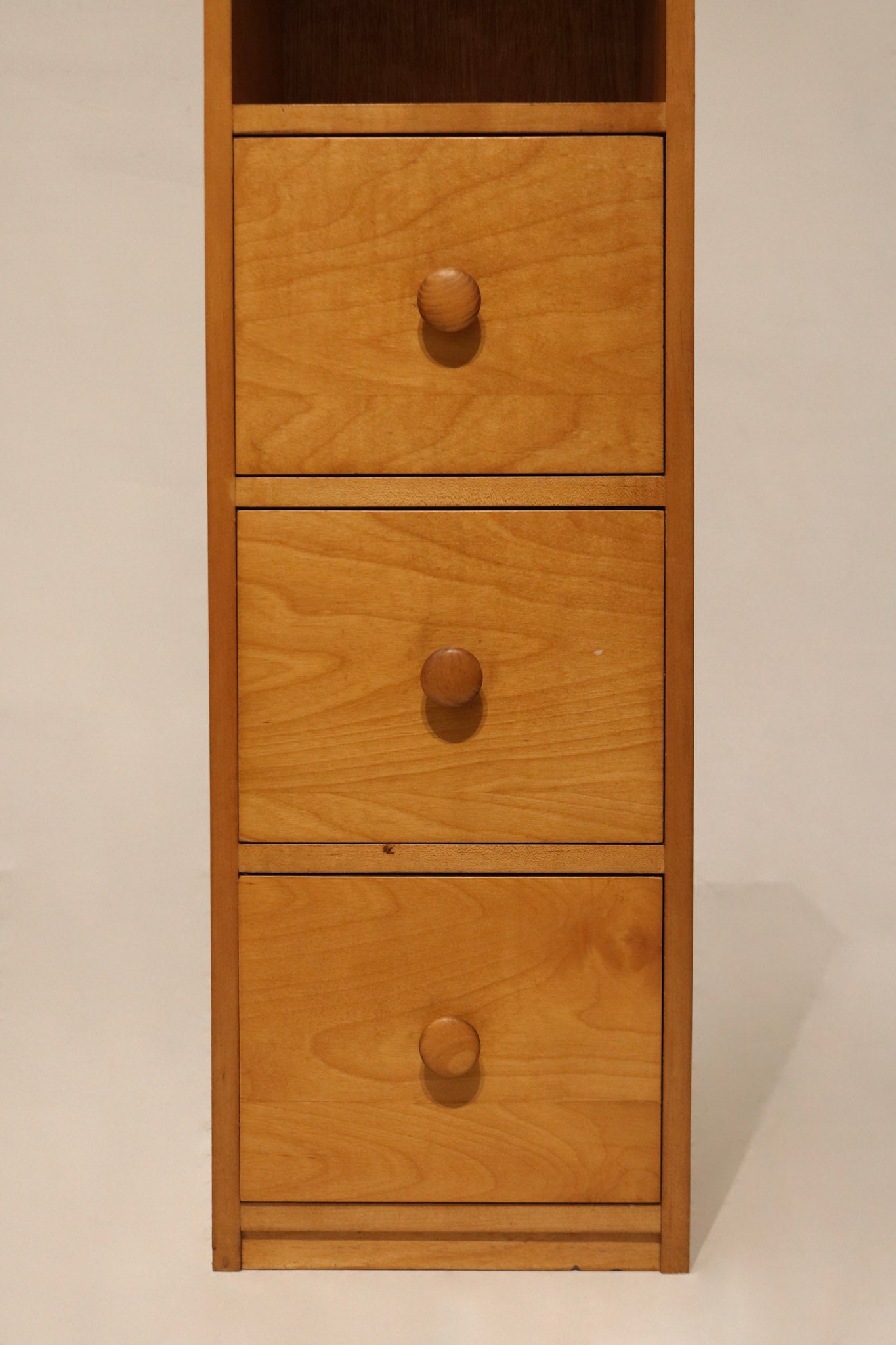 Close-up of drawer front on bookcase cabinet made of oak and particle board