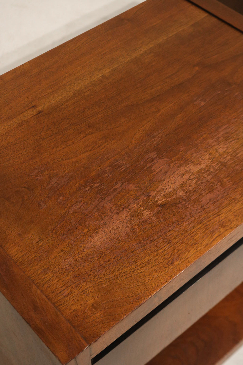 Construction detail: drawer runners, edge banding and joinery on walnut nightstands, illustrating durable mid-century build