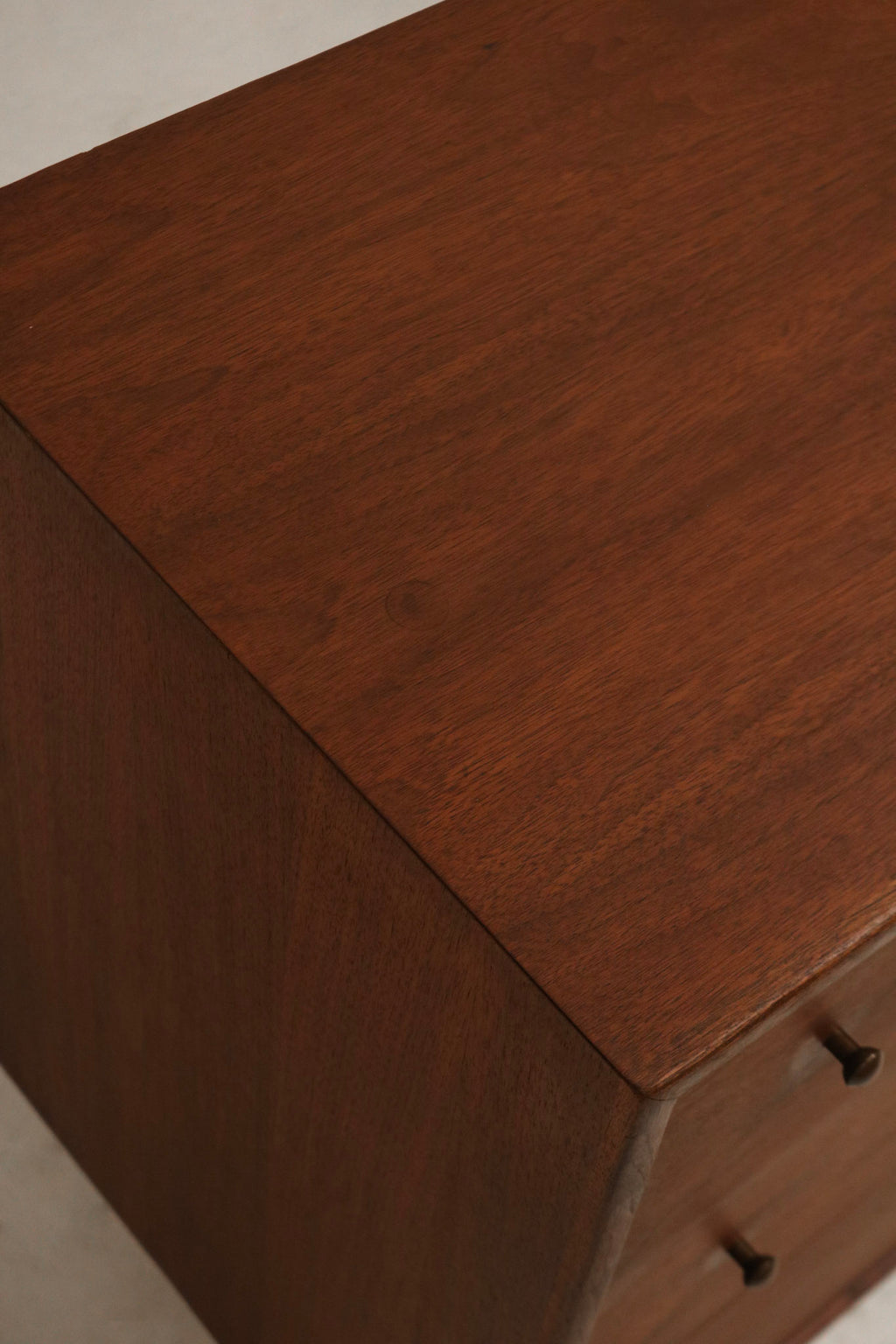 Legs detail showing mid-century tapered wood legs with warm walnut finish