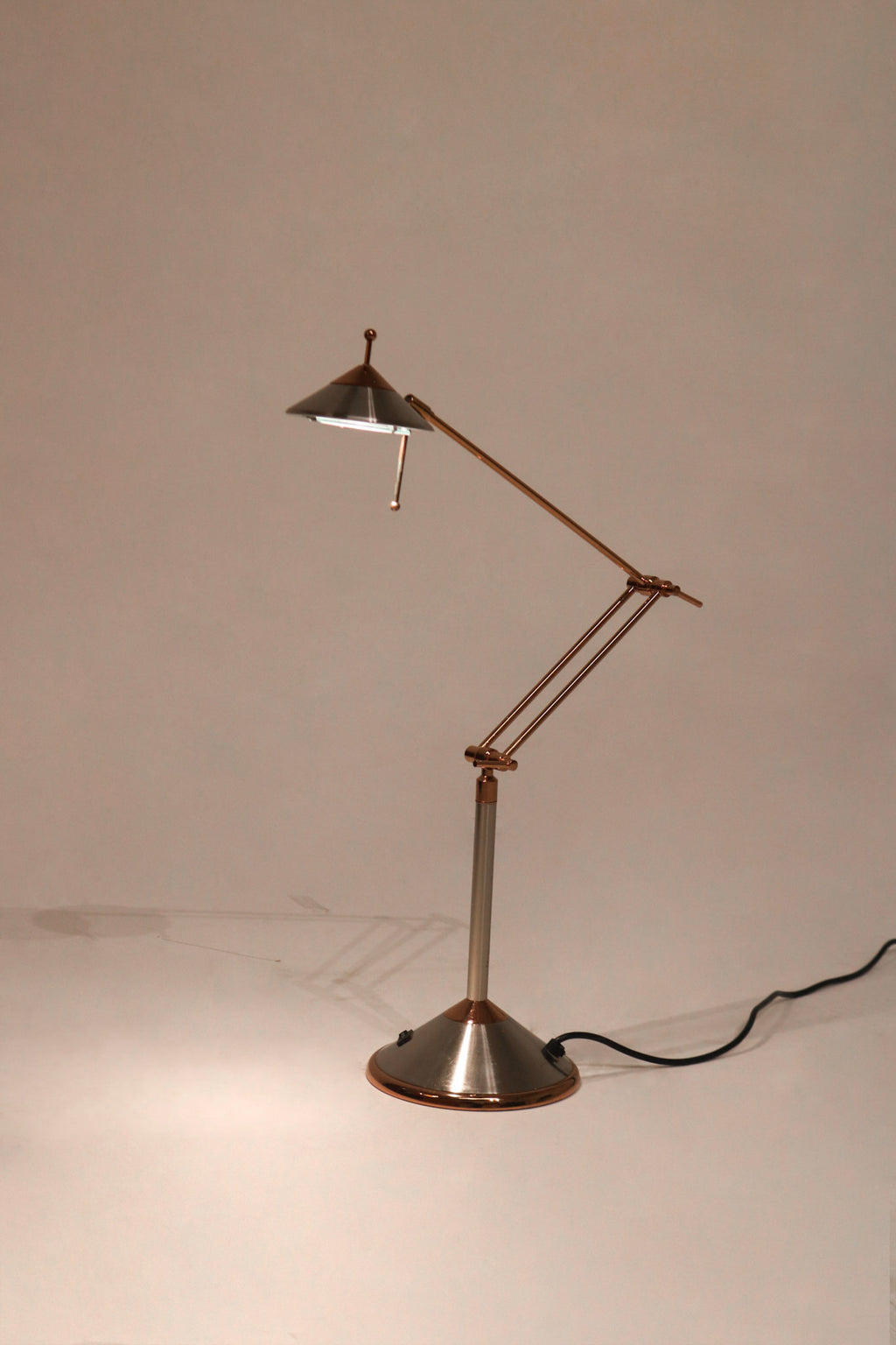 Full view of Vintage Chrome Adjustable Desk Lamp made of polished steel with adjustable arm on desk