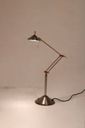 Full view of Vintage Chrome Adjustable Desk Lamp made of polished steel with adjustable arm on desk