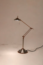 Full view of Vintage Chrome Adjustable Desk Lamp made of polished steel with adjustable arm on desk